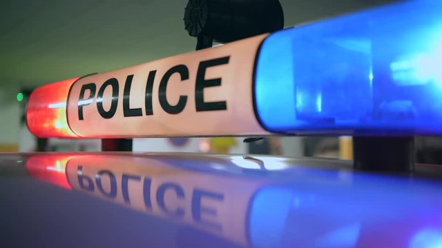 Police Cruiser Flashing Lights Closeup. Traffic Stop Concept.