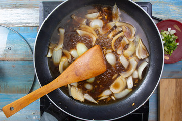 Chef stir fry onion in pan