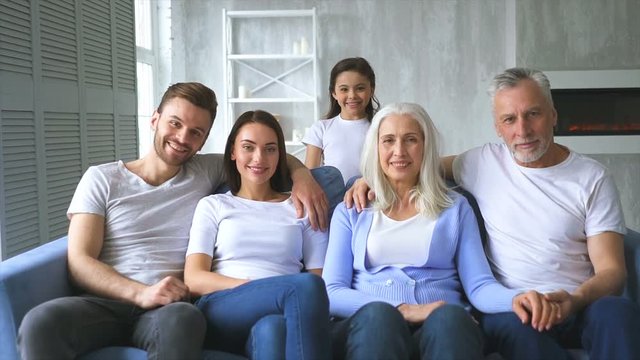 The happy family sitting on the sofa. slow motion