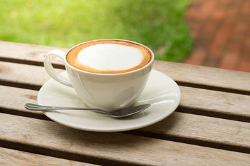 Hot coffee on wood table.