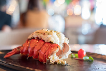 Grilled Lobster and vegetables on plate.