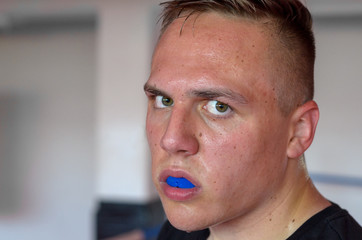 Sweaty young boxer wearing a mouthguard