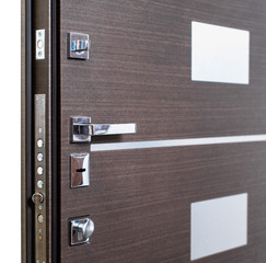 Open armored door. Door lock, Dark brown door closeup. Modern interior design, door handle. New...