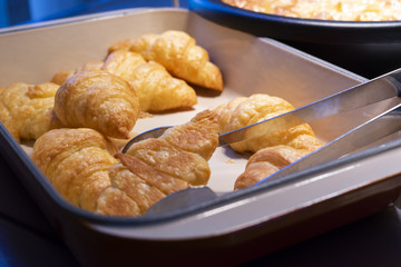 Fresh croissant in tray