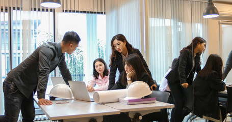 Asian businessmen and group using notebook for business partners discussing documents and ideas at meeting and business women smiling happy for working
