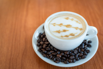 Hot coffee with art pattern in white cup