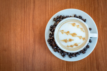 Hot coffee with art pattern in white cup
