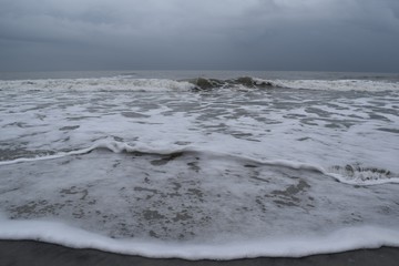 Waves Crashing On The Beach  After The Storm With Dark Sky