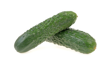 two green ripe cucumber on white background
