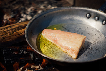 Cooking food for a picnic on a wood fire