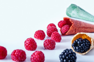 Frame isolated of Composition of fresh summer fruit, raspberries, blackberries and Cones on white background. Mediterranean diet with varied summer fruits. Stock photo.  Front View