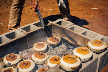 Cooking food for a picnic on a wood fire