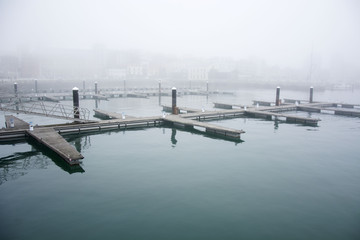 Photo of a marine with fog, cold colours and sunlight