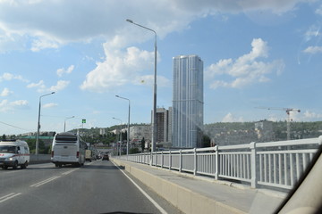 view of the bridge over the river and the city skyscraper from the car window
