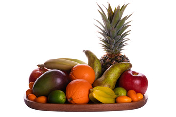 Fresh fruits on an acacia wooden plate front view