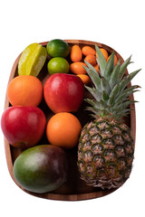 Fresh fruits on an acacia wooden plate up-view