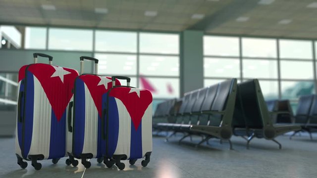 Travel suitcases featuring flag of Cuba. Cuban tourism conceptual animation
