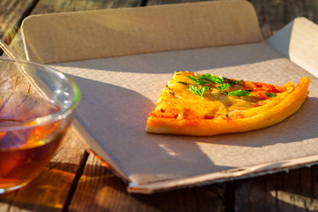 Pizza with tea on background