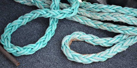 Strong blue rope on the deck of the ship. Tackles for a yacht. Rope rope for sea voyages