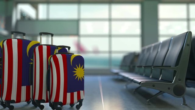 Travel suitcases featuring flag of Malaysia. Malaysian tourism conceptual animation