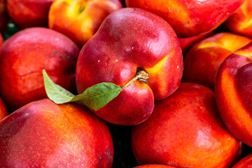 Fototapeta na wymiar Red peach piled high at market fresh from the farm