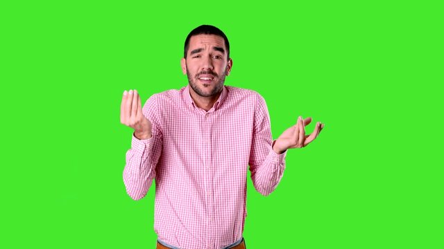 Confused young man doing a italian gesture of not understand - Chroma background