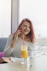 Portrait of young redhead attractive woman using mobile phone, close up