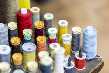 Colourful cotton bobbins and thread in a traditional tailors shop