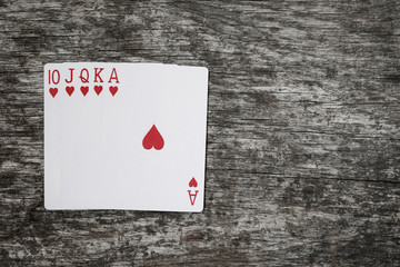 poker hand: royal flush. playing cards game abstract in wooden table