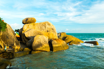 The Rock Hin Ta and Hin Yai from Thailand Island of Koh Samui. The picturesque pile of rocks on the beach, illuminated by the sunset.