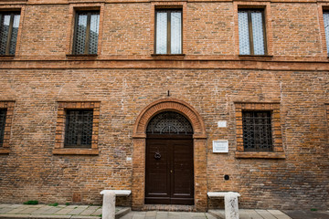Fototapeta na wymiar FERRARA, ITALY - May 01, 2018: entrance of the building where Ludovico Ariosto was born in Ferrara, Emilia-Romagna, Italy
