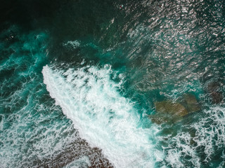 Aerial view from a surf spot with waves and a surfer in Ericeira, Portugal
