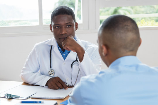 African american doctor listening to problems of patient