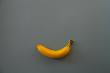 smile  banana on gray background health food concept