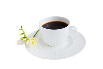 White cup of black coffee and white freesia flower isolated on white background