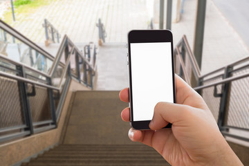 Hand of man using smartphone on stone stairs