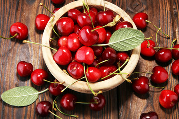 Cherry. Red fresh Cherries in bowl and a bunch of cherries on the table