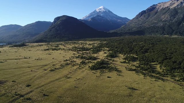 Aerial drone Scene mountains, trees and estepa, Camera moving forward and up to the Lanin volcano, Neuquen, Patagonia, Argentina