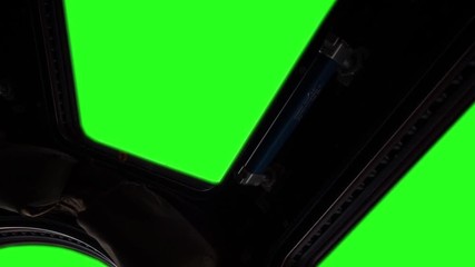 (ISS) International Space Station Window with Green Screen. Zoom In. Elements of this image furnished by NASA. 