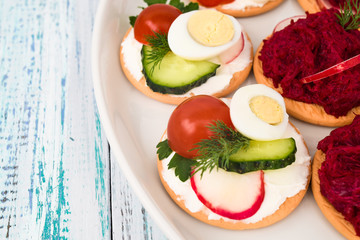 assortment of vegetable snacks with cucumbers, radishes, eggs and herbs