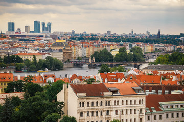 Fototapeta na wymiar Czech Republic, Prague, July 25, 2017: Panoramic view of the city. Red Roofs of houses and structures of the old city in the summer in cloudy cloudy weather