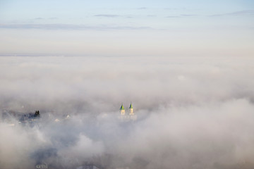 Fototapeta premium Church in fog from above