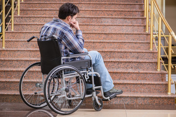Disabled man on wheelchair having trouble with stairs