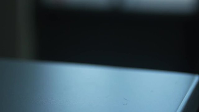 Keys On The Table. Male Hand Takes Two Metallic Keys Away From The Table. Zoom In.