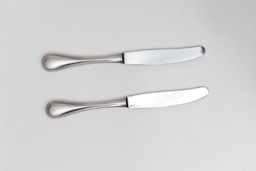Two knifes on white background in a studio
