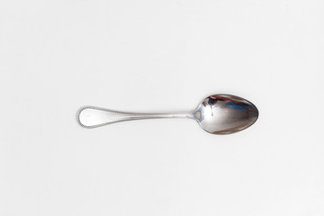 Single spoon on a white background in a studio