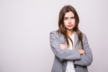 Portrait of an angry serious woman with folded arms isolated on a white background