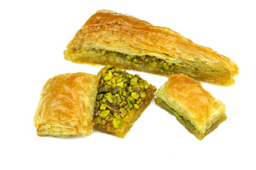 Delicious Turkish baklava with green pistachio nuts   isolated on white background.