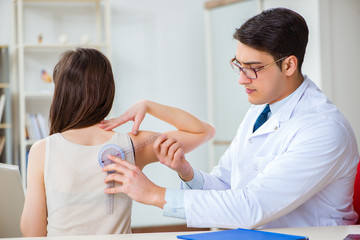 Doctor checking patients joint flexibility with gonimeter