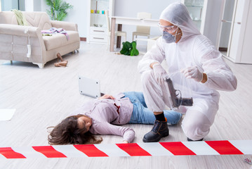 Forensic investigator at the crime scene investigating woman mur